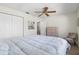 Spacious bedroom with a plush bed, closet, ceiling fan, and wooden dresser at 6209 Heritage Ln # 6209, Bradenton, FL 34209