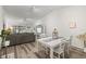 Bright dining room with white table, four chairs, and wood-look floors connected to the living area at 6209 Heritage Ln # 6209, Bradenton, FL 34209