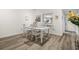 Cozy dining area featuring wood-look flooring, a white table, and decor-friendly neutral colors at 6209 Heritage Ln # 6209, Bradenton, FL 34209
