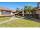 Charming single story home featuring lush landscaping, a quaint walkway, and covered entrance at 6209 Heritage Ln # 6209, Bradenton, FL 34209