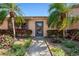 Inviting home showcasing a walkway and lush landscaping with vibrant plants and mature trees at 6209 Heritage Ln # 6209, Bradenton, FL 34209