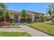 Charming home with mature landscaping, including palm trees and colorful shrubbery, creating curb appeal at 6209 Heritage Ln # 6209, Bradenton, FL 34209