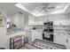Bright kitchen with white cabinets, granite countertops, and stainless-steel appliances at 6209 Heritage Ln # 6209, Bradenton, FL 34209