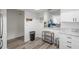Spacious area near the kitchen with wood-look flooring, white walls, and granite countertop feature at 6209 Heritage Ln # 6209, Bradenton, FL 34209