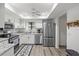 Modern kitchen featuring stainless steel appliances, granite countertops, and white cabinets at 6209 Heritage Ln # 6209, Bradenton, FL 34209