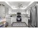 Well-lit kitchen with stainless steel appliances, granite counters, and white cabinets for a modern look at 6209 Heritage Ln # 6209, Bradenton, FL 34209