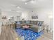 Spacious living room with sectional sofa and blue rug, open to the dining area at 6209 Heritage Ln # 6209, Bradenton, FL 34209