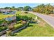 Community entrance to Meadowcroft South is well maintained with mature landscape on a sunny day at 6209 Heritage Ln # 6209, Bradenton, FL 34209
