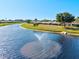 Scenic view of community pond with fountain and lush green space, creating a relaxing atmosphere at 6209 Heritage Ln # 6209, Bradenton, FL 34209