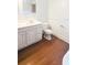 This bathroom features a classic white vanity and beautiful, dark, hardwood floors at 624 19Th W St, Bradenton, FL 34205