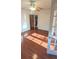 Spacious bedroom with hardwood flooring, ceiling fan, and interior glass paneled doors at 624 19Th W St, Bradenton, FL 34205