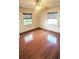 Comfortable bedroom with hardwood flooring, two windows, and neutral walls at 624 19Th W St, Bradenton, FL 34205