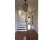 Entryway featuring a staircase with hardwood treads and decorative light fixture at 624 19Th W St, Bradenton, FL 34205