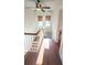 Hallway with hardwood floors and storage, illuminated by natural light from windows at 624 19Th W St, Bradenton, FL 34205