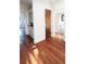 Hallway view with hardwood flooring, built-in cabinet and bathroom view at 624 19Th W St, Bradenton, FL 34205