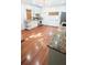 Open kitchen area with stainless steel appliances, granite countertops, and hardwood floors at 624 19Th W St, Bradenton, FL 34205