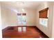 Bright living room featuring hardwood floors, large windows, and an elegant chandelier for a grand space at 624 19Th W St, Bradenton, FL 34205