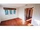 Bright and open living area with hardwood floors, glass doors, and multiple windows at 624 19Th W St, Bradenton, FL 34205