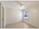 Bright bedroom with a ceiling fan, tile floors and a view to the outside at 6240 7Th W Ave # 6240, Bradenton, FL 34209