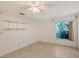 Bedroom with a ceiling fan, tile floors, shelves and a window with a view to the outside at 6240 7Th W Ave # 6240, Bradenton, FL 34209