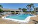 Community pool surrounded by palm trees and white fencing at 6240 7Th W Ave # 6240, Bradenton, FL 34209