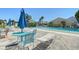 Relaxing community pool area with a patio table, chairs, lounge chairs, and umbrellas for outdoor enjoyment at 6240 7Th W Ave # 6240, Bradenton, FL 34209