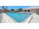 Inviting community pool featuring lounge chairs, blue umbrellas, and clear blue water for residents enjoyment at 6240 7Th W Ave # 6240, Bradenton, FL 34209