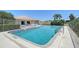 Sparkling community pool with a metal railing and inviting blue tile accents for leisure and recreation at 6240 7Th W Ave # 6240, Bradenton, FL 34209