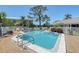 Community pool surrounded by palm trees and lounge chairs at 6240 7Th W Ave # 6240, Bradenton, FL 34209