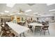 Bright recreation room with tables, chairs, library, and lounge space at 6240 7Th W Ave # 6240, Bradenton, FL 34209