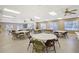Bright recreation room with tables, chairs, TV and outdoor access at 6240 7Th W Ave # 6240, Bradenton, FL 34209