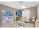 Bright sitting area with ceiling fan, white furniture and pool access at 6240 7Th W Ave # 6240, Bradenton, FL 34209