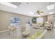Bright room with ceiling fan, white furniture and pool view at 6240 7Th W Ave # 6240, Bradenton, FL 34209