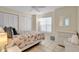 Comfortable bedroom with tile flooring and a large window with blinds at 6415 39Th W Ave, Bradenton, FL 34209