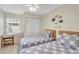 Bedroom with two twin beds, a ceiling fan and tile flooring at 6415 39Th W Ave, Bradenton, FL 34209