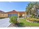 Charming home with a terracotta tile roof, vibrant landscaping, and a spacious driveway at 6415 39Th W Ave, Bradenton, FL 34209