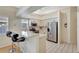 Open kitchen with breakfast bar, stainless steel appliances, and light countertops at 6415 39Th W Ave, Bradenton, FL 34209