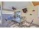 Covered patio with outdoor dining set, ceiling fan, and access to the pool area at 6415 39Th W Ave, Bradenton, FL 34209