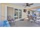 Cozy covered patio featuring a ceiling fan, patio furniture, and sliding door access to indoors at 6415 39Th W Ave, Bradenton, FL 34209