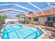 Backyard screened in pool with a tile roof and patio with outdoor furniture at 6415 39Th W Ave, Bradenton, FL 34209