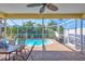 Relaxing screened-in pool area with ceiling fan, outdoor seating and dining table at 6415 39Th W Ave, Bradenton, FL 34209