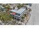 Aerial shot of a contemporary home featuring a flat roof, and situated in a beachfront community at 6603 Gulfside Rd, Longboat Key, FL 34228