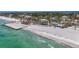Aerial of beachfront homes in a coastal community with ocean views and modern architectural designs at 6603 Gulfside Rd, Longboat Key, FL 34228