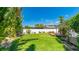 Lush backyard with a well-manicured lawn, tropical foliage and a wooden deck at 6628 Keystone Dr, Sarasota, FL 34231