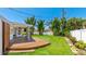Expansive backyard featuring a wooden deck and a lush green lawn at 6628 Keystone Dr, Sarasota, FL 34231