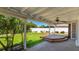 Serene backyard featuring a covered patio, a ceiling fan, and a view of the fenced lawn at 6628 Keystone Dr, Sarasota, FL 34231