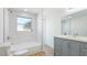 Elegant bathroom featuring white tile, a modern vanity, and shower-tub combination at 6628 Keystone Dr, Sarasota, FL 34231