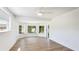 Sunlit bedroom features multiple large windows offering serene views of surrounding greenery at 6628 Keystone Dr, Sarasota, FL 34231