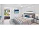 Comfortable bedroom featuring a queen bed, neutral decor, and an exit to a patio at 6628 Keystone Dr, Sarasota, FL 34231