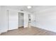 Clean bedroom featuring light wood floors, white walls, and closet with sliding doors at 6628 Keystone Dr, Sarasota, FL 34231
